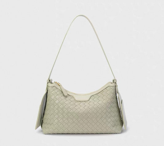 Light gray woven handbag on a white background